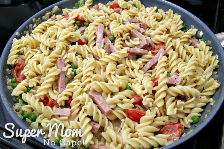 Fisulli pasta mixed with ham, peas and sauce