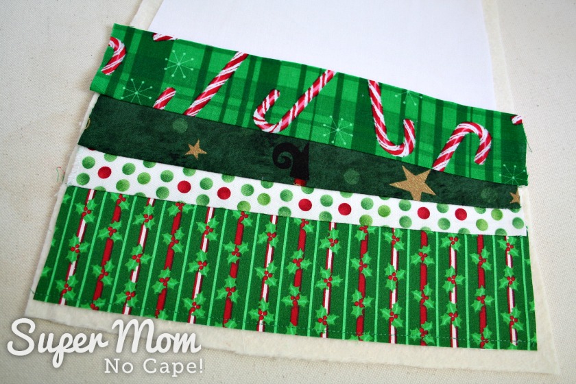 Four strips of Christmas fabric sewn to stocking base