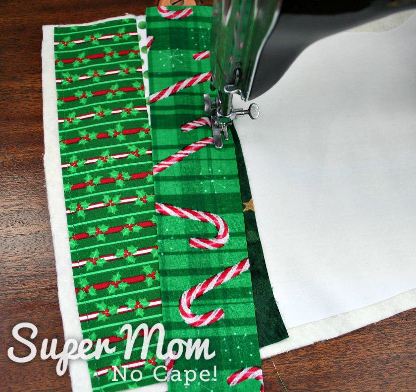Sewing a strip of fabric to the stocking base with the strip on an slight angle