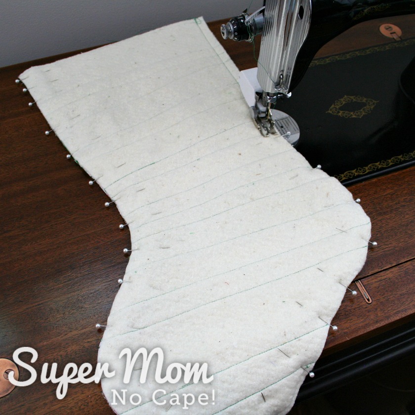 The two quilted stocking pieces pinned and being sewn together.