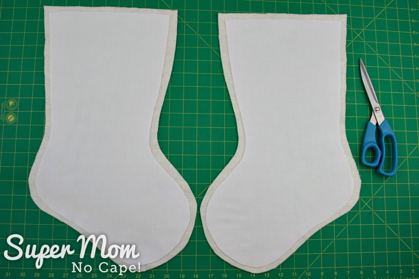 White fabric stocking shapes layered on batting to make the stocking base.