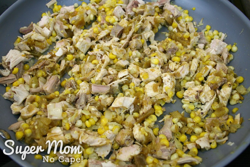 A picture of the filling with the corn, chopped turkey and onions in a frying pan