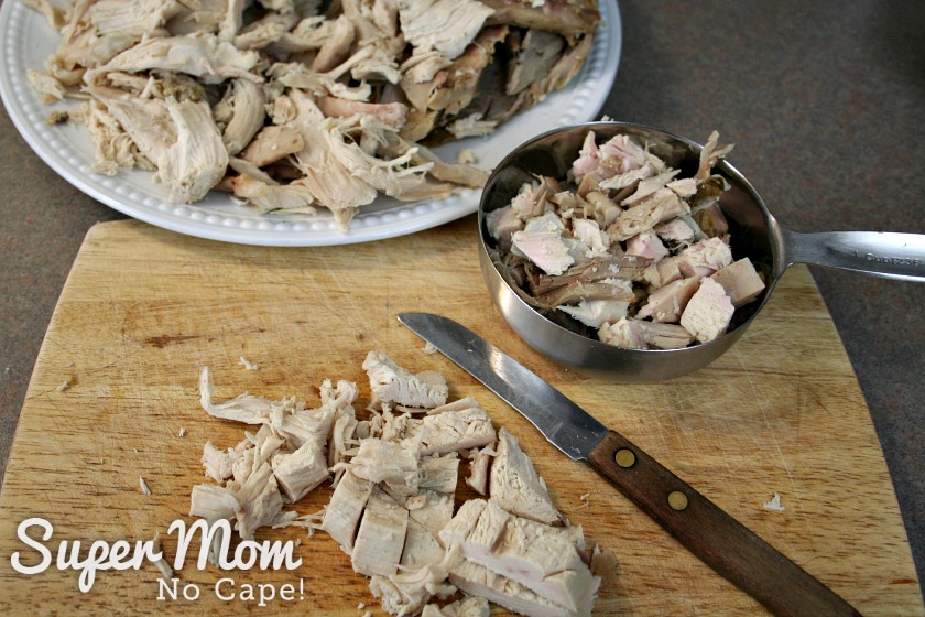A picture of turkey being cut up into bite size pieces for the filling.