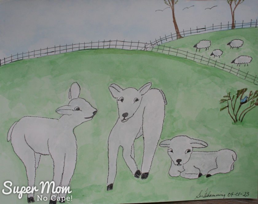 Photo of March's Calendar Page - Watercolor painting of three cute spring lambs with sheep in the background.