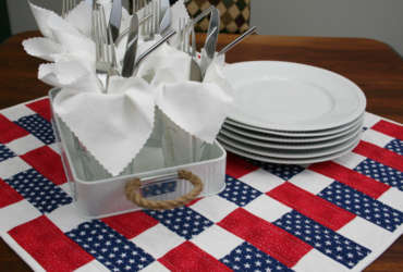 old glory table cover with dinner plates and utensils