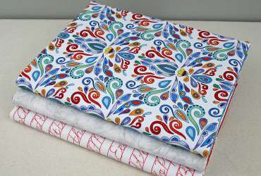 Photo of three fabric covered composition books in three different fabrics.