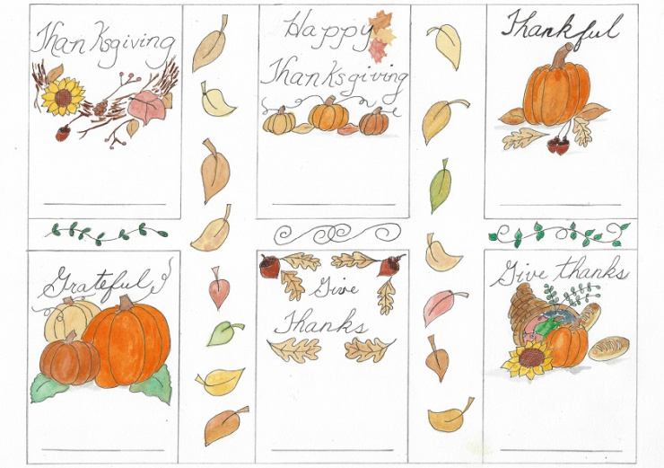 Picture of Thanksgiving place cards. There are pictures of pumpkins, leaves and acorns.